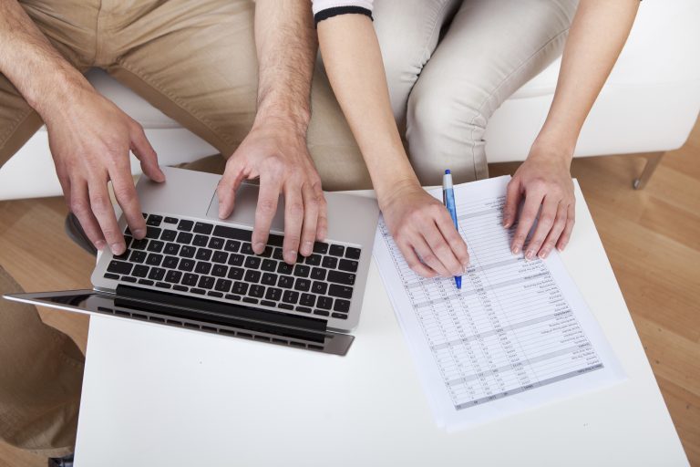 Young couple doing finances at laptop